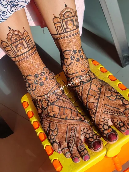 Heavy bridal legs featuring architectural dome motifs and intricate floral and elephant patterns.