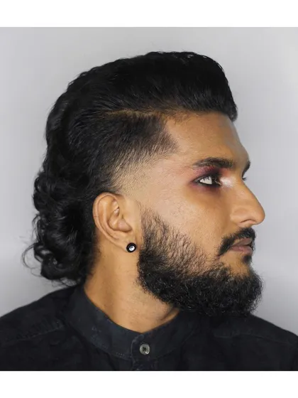 A modern mullet with a temp fade. I love getting creative and working on alternative styles that push the boundaries of men's grooming.
