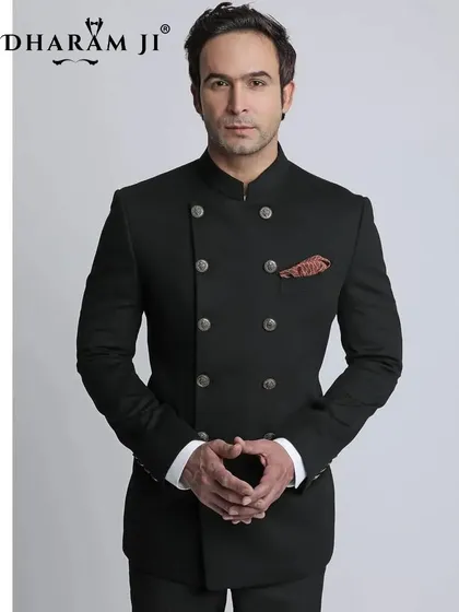 A model wearing a black double-breasted bandhgala suit. This is a powerful and modern take on the traditional Jodhpuri suit, tailored for a clean and commanding presence.