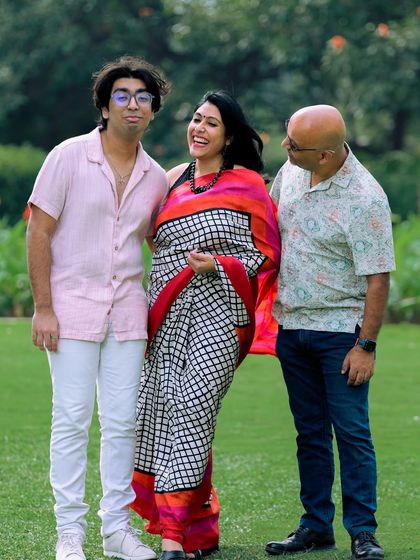 Laughter is the best ingredient for a family portrait. This image captures a moment of pure joy and connection between parents and their son.