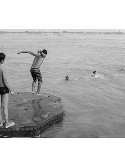The black and white version of the boys jumping into the Ganga. Stripped of color, the focus shifts to the form, motion, and the timeless nature of this activity.