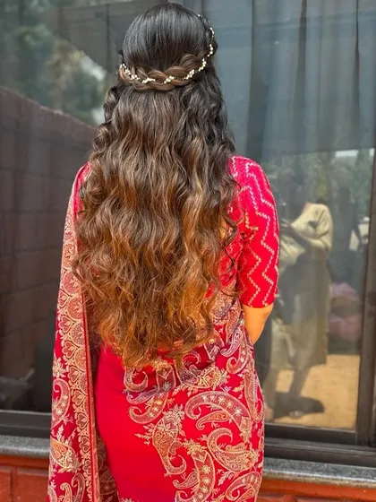 An absolutely timeless look for any wedding or special occasion. We created soft, flowing waves and a delicate crown braid for a romantic and elegant half-up hairstyle that perfectly complements her traditional attire.