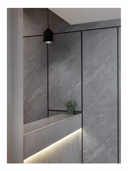 The reception area of the 'Shadows' law office explores the grey area between black and white. The textured grey wall panels and minimalist lighting create a first impression that is modern, serious, and sophisticated.