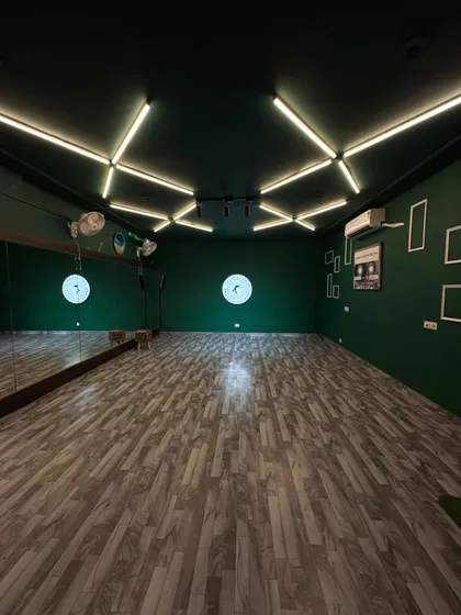 Welcome to Flex Studio. We designed this space as a clean, creative canvas with professional green walls, custom lighting, and a full-length mirror for you to bring your vision to life.