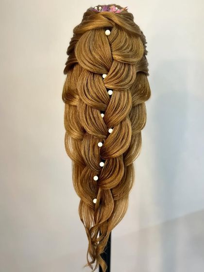 A stunning example of a multi-layered, pull-through braid, embellished with pearls for an elegant finish.
