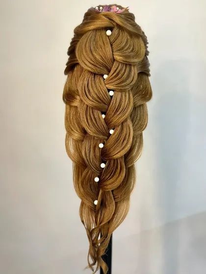 A stunning example of a multi-layered, pull-through braid, embellished with pearls for an elegant finish.