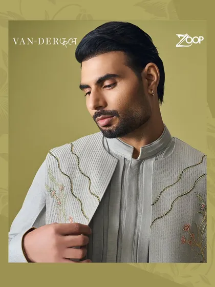 A close-up of a grey Vanderphool jacket with wavy embroidery and subtle floral details. This piece blends modern design with a touch of nature's grace.