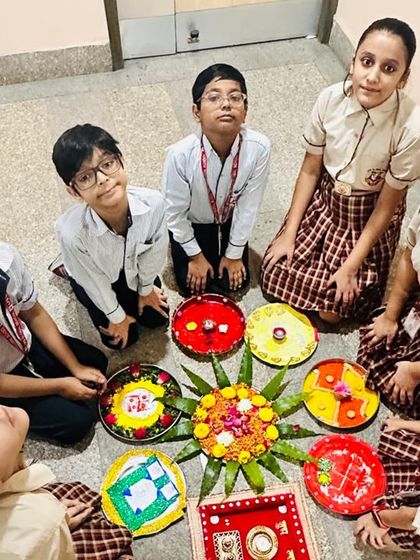 Students gather on the floor with their beautifully decorated puja thalis and rangoli designs. Our Diwali competitions encourage creativity and a deeper understanding of festive rituals.