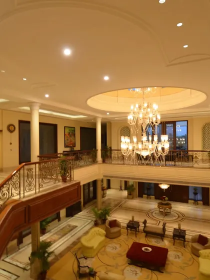 We indulge in the splendor of neo classical architecture, where opulent chandeliers, intricately carved pillars, and breathtaking jaali windows grace every corner, creating a realm of refined luxury.