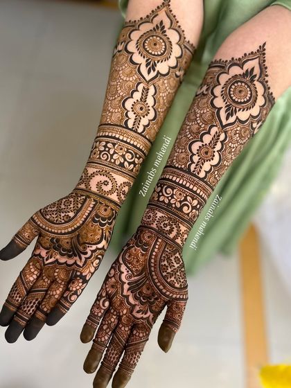 Another angle of Maheen's full bridal henna, highlighting the matching designs on both arms.