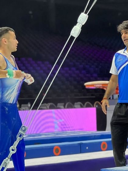 A moment of focused instruction between coach and athlete during podium training at the World Championships. Communication and strategy are key at this level.