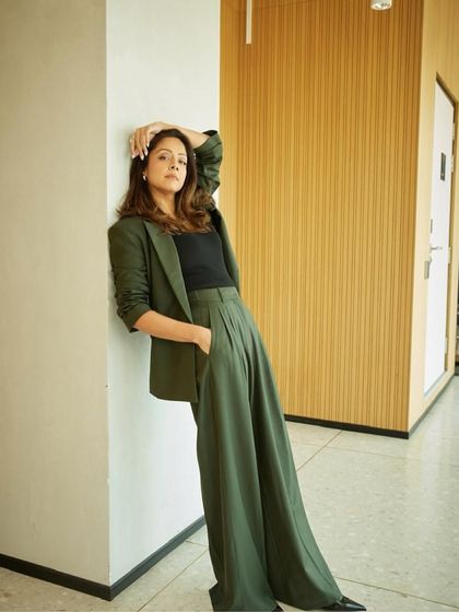 A full-length shot showing the relaxed yet polished vibe of this olive green power suit.