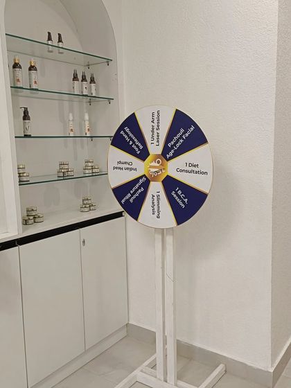 At our new Vasundhara clinic, we have a fun way for guests to experience our services. This prize wheel includes complimentary sessions like an underarm laser session, a diet consultation, or an age lock facial. It's a small way for us to give back to our community.