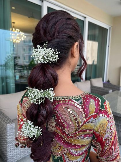 A full view of the burgundy bubble braid with baby's breath, a unique and stylish choice for any wedding event.