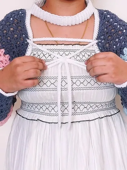 The front of the Gaea Shrug features a corset-style lacing, adding another layer of detail to this intricate design.