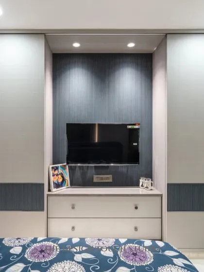 A close-up of the TV unit, which is cleverly built into the sliding wardrobe system. This innovative solution saves space and maintains a clean, modern aesthetic.