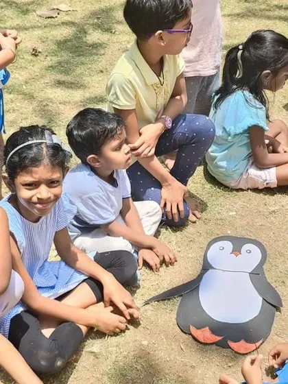 Learning about different animals and their habitats during a summer camp activity. The plush penguin was a big hit and sparked a great conversation about Antarctica.