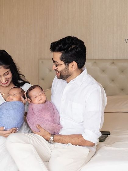 A lifestyle family portrait with newborn twins on the bed. These sessions are relaxed and capture your family naturally.