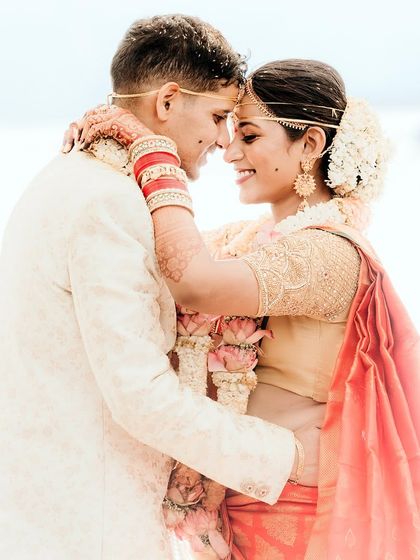An intimate and bright portrait of the couple. The high-key lighting and their close embrace create a dreamy and romantic feel.