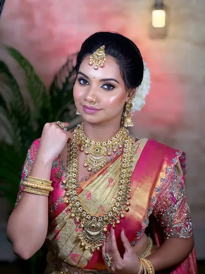 An elegant South Indian bride. I focus on creating an authentic look, complete with traditional temple jewellery, a classic hairstyle, and makeup that highlights the bride's grace.