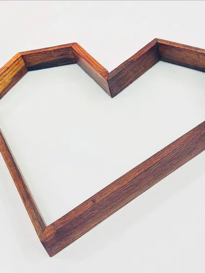 A close-up view of our 10x15 inch heart-shaped teakwood frame. The solid wood construction provides a beautiful, natural border for preserving wedding garlands or creating custom resin decor.
