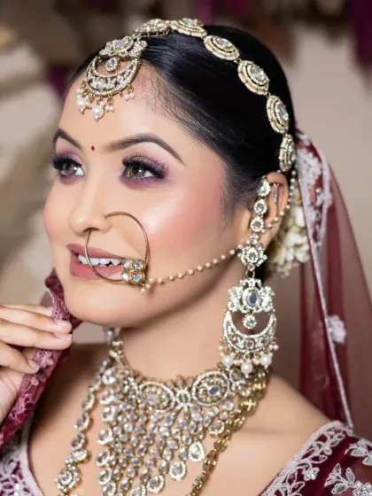 The final portfolio is your key to getting bookings. This is another example of a student's work, capturing a beautiful side profile with intricate jewelry and a perfectly executed eye makeup look.
