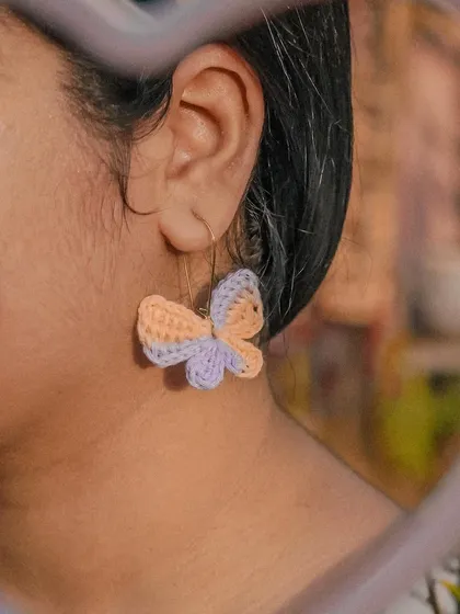 This is the vibe. A close-up of my handmade Titli (butterfly) earrings, crafted from 100% cotton yarn so they're super lightweight. They add that perfect whimsical touch to any look.