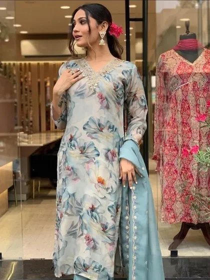 A grey premium organza kurta with a soft floral print. The delicate thread embroidery on the neckline adds a touch of elegance.