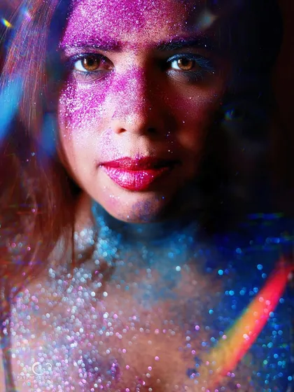 A beautiful and surreal portrait using a prism or double exposure effect over the glitter makeup. The result is a multi-layered, kaleidoscopic image.
