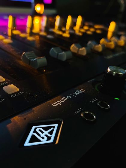 A close-up of our Universal Audio Apollo X8P interface. This device is the heart of our studio, providing elite-class audio conversion and real-time UAD processing.