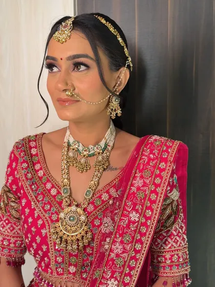 A close-up of her bridal makeup, featuring a soft purple eyeshadow and a flawless, glowing base.