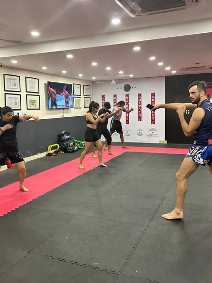 Our classes move together, building a shared rhythm and energy. Students practice their striking stance and punches in unison, learning the foundational movements of boxing and kickboxing.