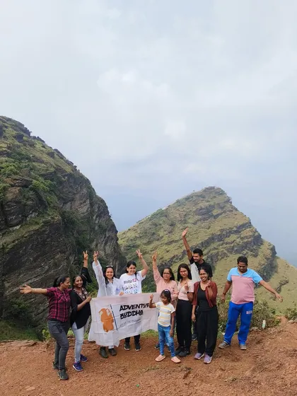 A group of women and a child posing at Ettina Bhuja peak in Chikmagalur. Our trips are for everyone.