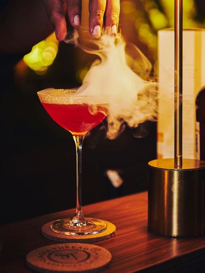 A unique creation for a private party. This martini combines the flavors of blood orange and Himalayan rhododendron, finished with a dramatic swirl of smoke.