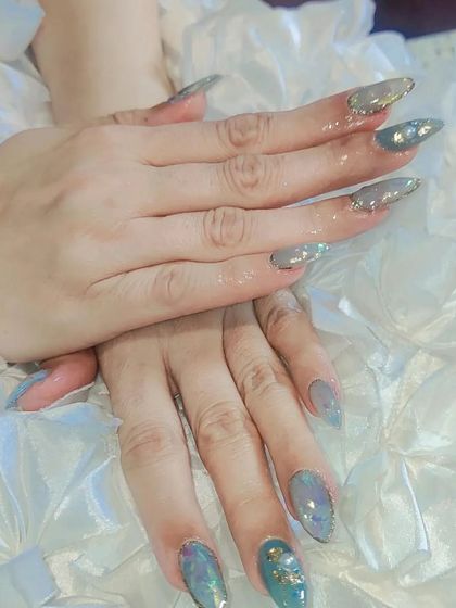 The full view of the long stiletto nails with the stunning blue and gold encapsulated design. This set is a true work of art.