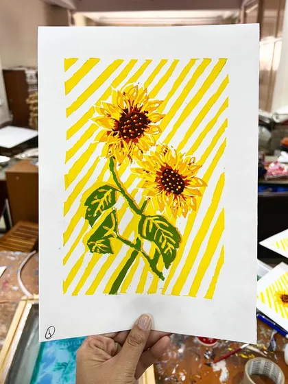 A beautiful two-color silkscreen print of sunflowers, created by a student in our Delhi studio. The layering of colors brings the artwork to life.