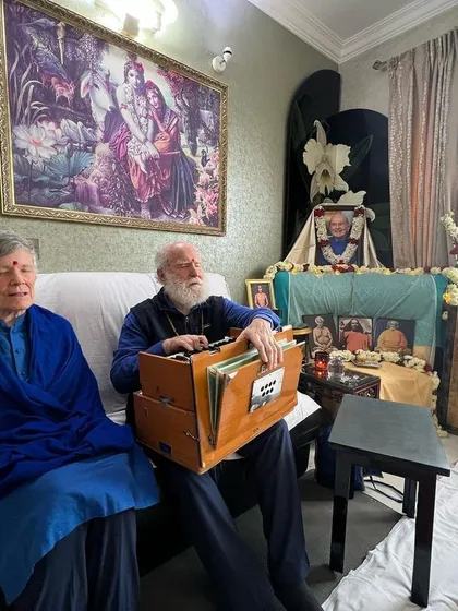 Nayaswami Jyotish and Devi lead a small satsang in a devotee's home. The altar shows how any space can be made sacred by inviting the presence of the masters.