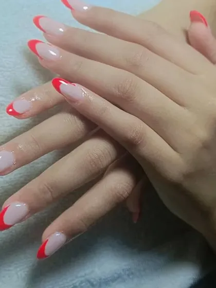 You can never go wrong with a classic red French manicure. This elegant design features sharp, almond-shaped nails with a clean nude base and vibrant red tips.