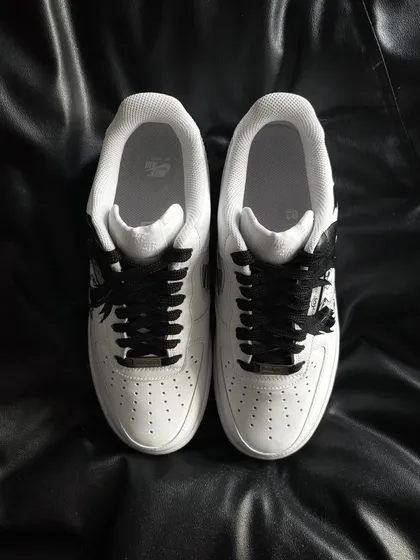 A top-down view of the Itachi custom sneakers, highlighting the clean design and black laces.