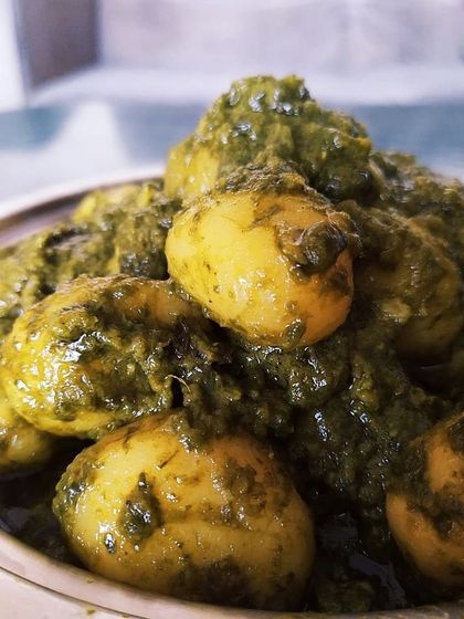 Shobuj Aloor Dom, a delicious winter dish made with baby potatoes in a green spinach-based gravy. This recipe was introduced to my family right after my wedding and brings back many lovely memories.