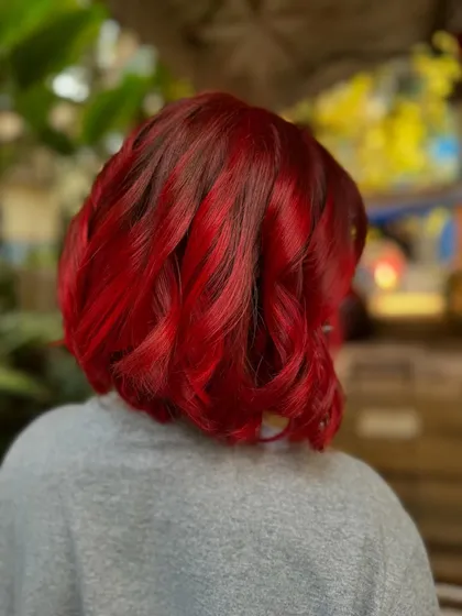 Another angle of the fiery red bob. The color is so rich and vibrant, it's impossible to ignore. This is a bleach color.