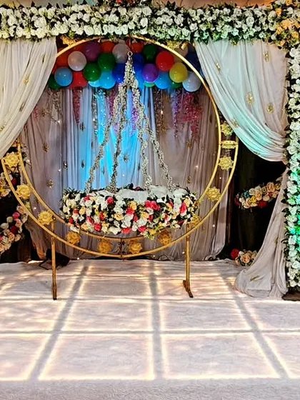 A beautiful setup for a 'barsa' or naming ceremony. We arranged a traditional floral cradle on our LED stage, with Krishna-themed cutouts and balloon decorations, creating a divine atmosphere for welcoming the new baby.