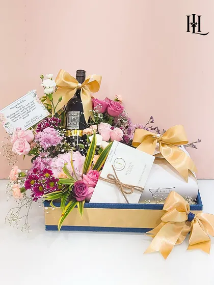The complete birthday hamper, beautifully presented in a blue and gold box. The combination of wine, flowers, and a spa voucher makes it a truly luxurious and thoughtful gift.