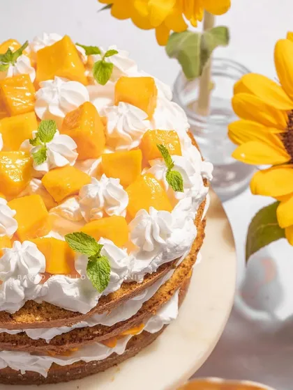 Another look at my Fresh Cream Mango Cake, surrounded by sunflowers. It’s a simple, classic dessert that lets the flavor of the fresh mangoes shine.