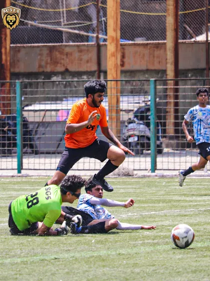 A moment of agility as our player leaps over a sliding opponent to continue the attack.
