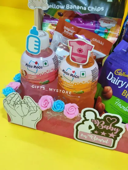 A close-up of the cute elements in my baby shower hamper, including "mom-to-be" and "dad-to-be" themed drinks.