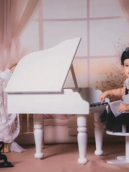 An elegant portrait of a little girl at the white piano, creating a soft and dreamy mood.