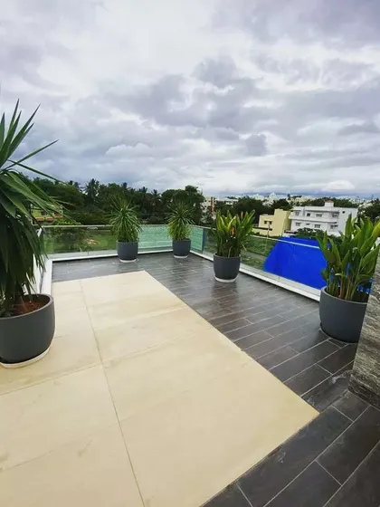 Another view of the spacious Mysore terrace. I used large, grey pots to complement the flooring and planted hardy, architectural plants like Yucca to create a strong visual statement against the open sky.
