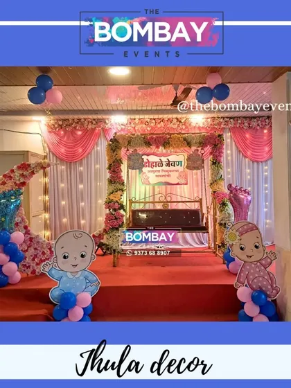 A classic and elegant Dohale Jevan setup. The beautifully decorated jhula is the centerpiece, complemented by a floral moon, soft drapery, and cute baby cutouts for a picture-perfect event.