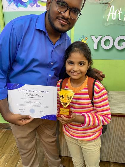 Aadhya Shetty, one of our talented young chess players, receives her participation award at the academy's tournament.